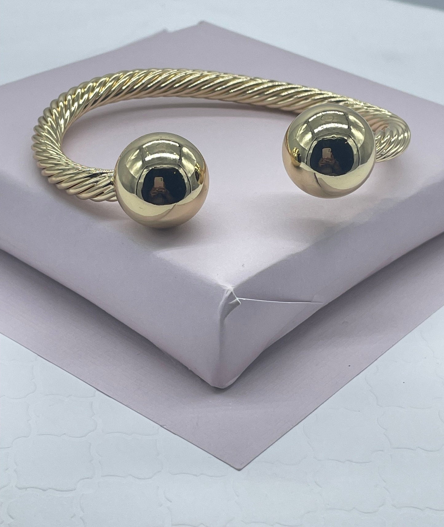 18k Gold Layered Twisted Bangle Featuring Two Solid Balls On Top Wholesale